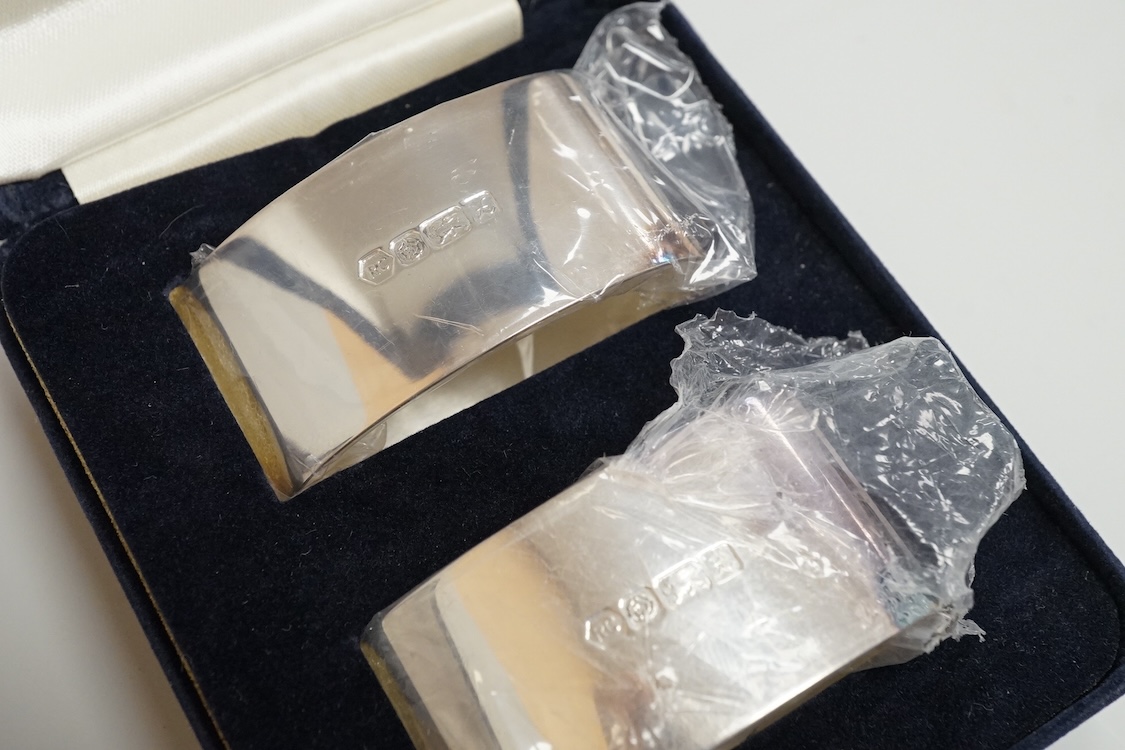 Two boxed pairs of Elizabeth II silver napkin rings by Carr's of Sheffield, Sheffield, 1997.